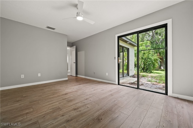 spare room with ceiling fan and hardwood / wood-style floors