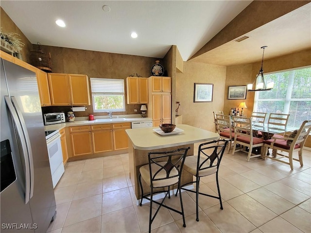 kitchen with white appliances, visible vents, light countertops, light brown cabinetry, and light tile patterned flooring