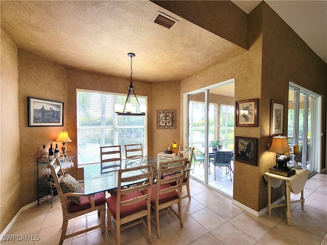 dining area featuring visible vents, a textured ceiling, baseboards, and light tile patterned flooring