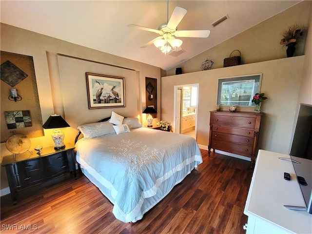 bedroom featuring wood finished floors, visible vents, a ceiling fan, vaulted ceiling, and ensuite bath