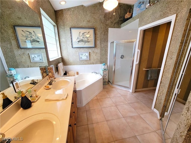 bathroom with a garden tub, wallpapered walls, a sink, a shower stall, and tile patterned floors