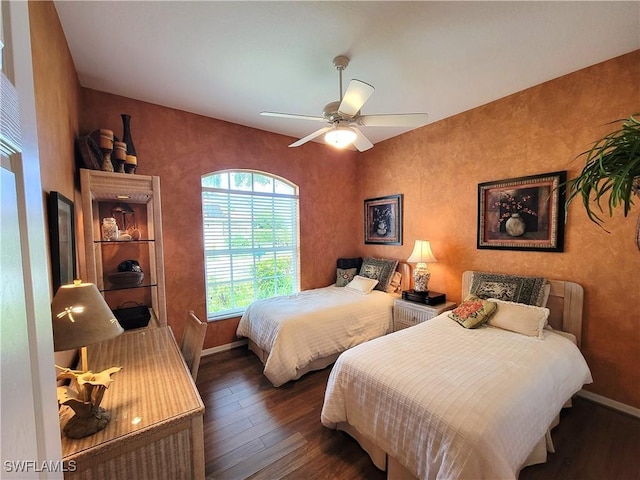 bedroom featuring ceiling fan, baseboards, and wood finished floors