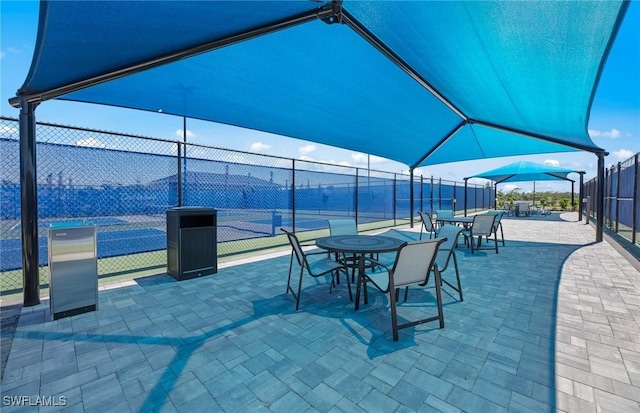 view of patio / terrace with tennis court