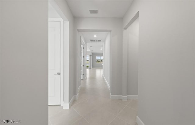 hall featuring light tile patterned floors