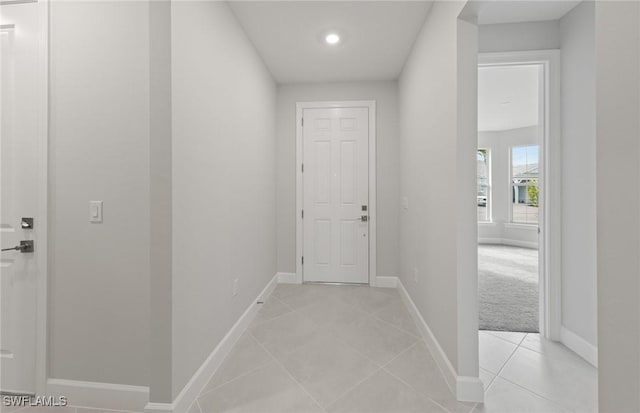 hallway featuring light colored carpet