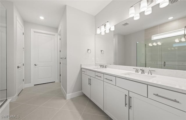 bathroom featuring vanity, tile patterned flooring, and walk in shower