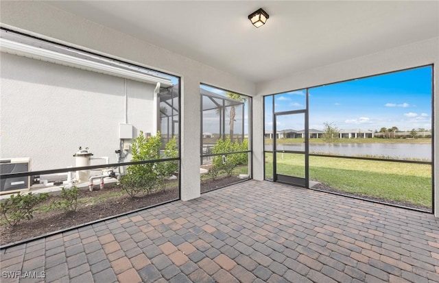 unfurnished sunroom with a water view