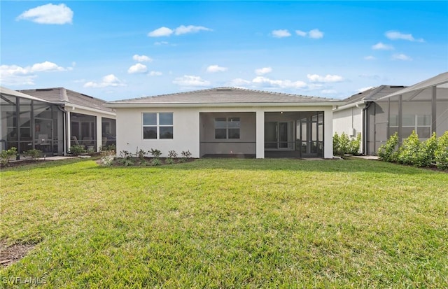 rear view of house featuring a lawn