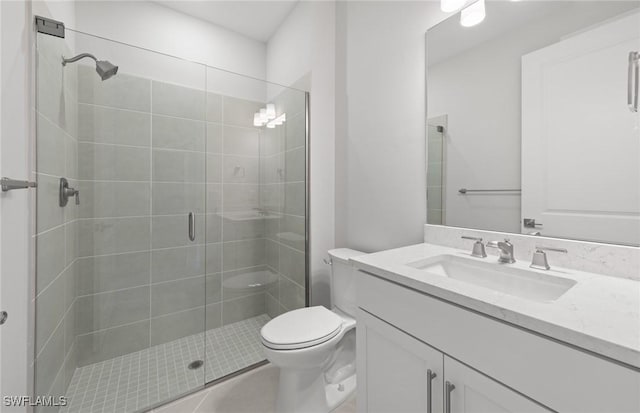 bathroom with tile patterned floors, vanity, toilet, and an enclosed shower