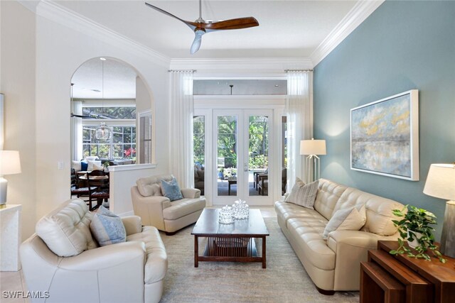 living room with ceiling fan, ornamental molding, and french doors