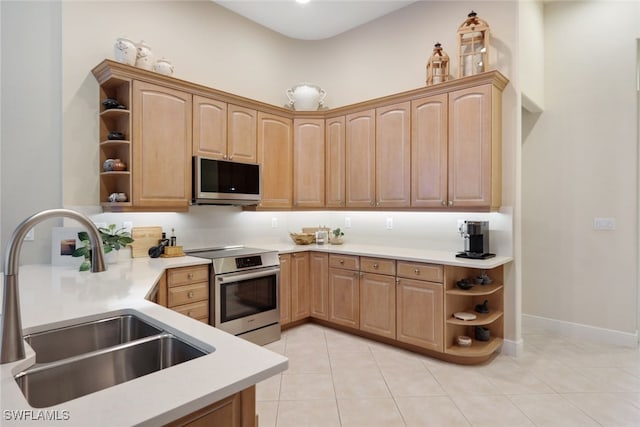 kitchen featuring light tile patterned flooring, range, sink, and a towering ceiling