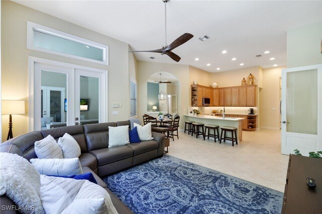 tiled living room with sink and ceiling fan