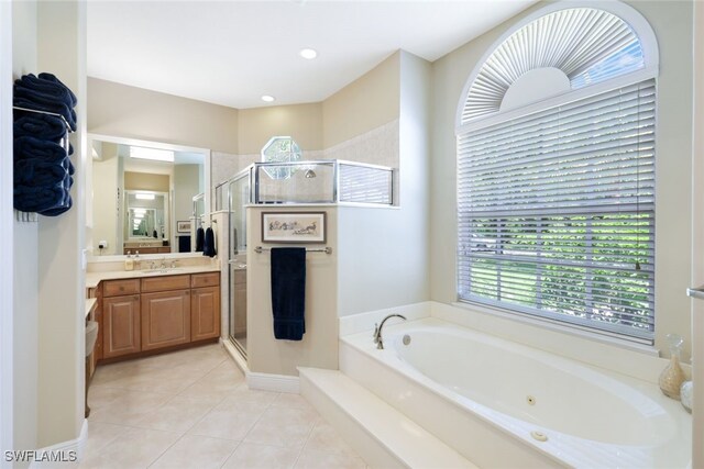 bathroom featuring tile patterned flooring, vanity, a healthy amount of sunlight, and shower with separate bathtub