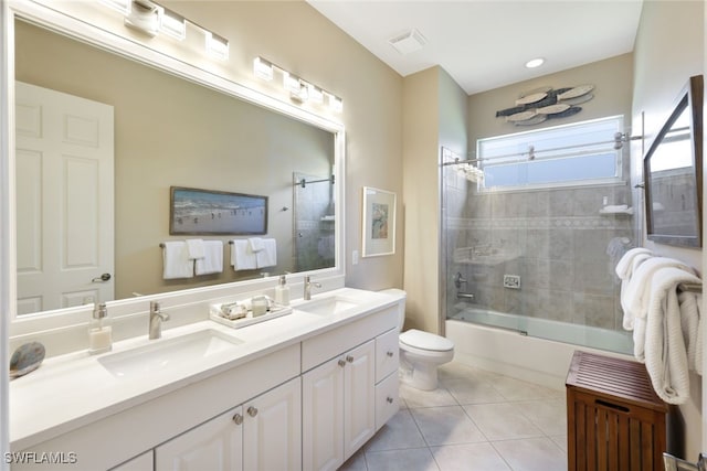 full bathroom with bath / shower combo with glass door, toilet, tile patterned floors, and vanity