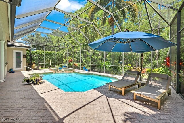 view of swimming pool with an in ground hot tub, glass enclosure, and a patio