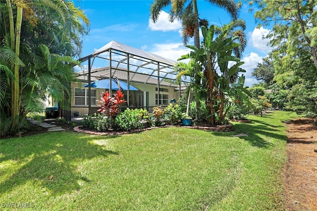 view of yard with glass enclosure