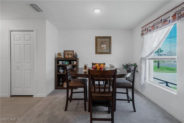 dining space with light carpet