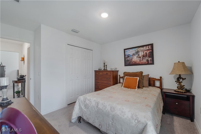 bedroom with a closet and light colored carpet