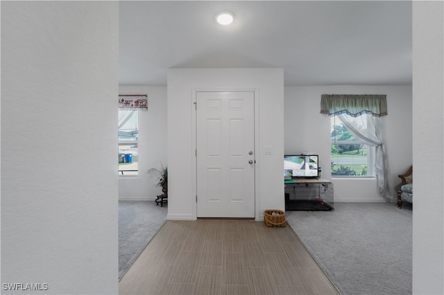 foyer featuring carpet flooring