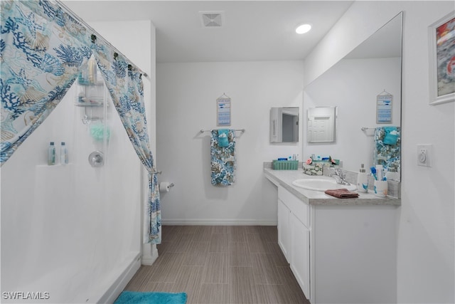 bathroom with tile patterned flooring and vanity