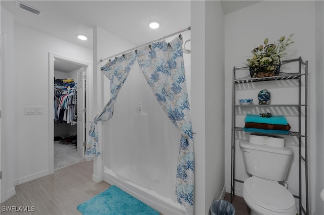 bathroom with toilet and walk in shower