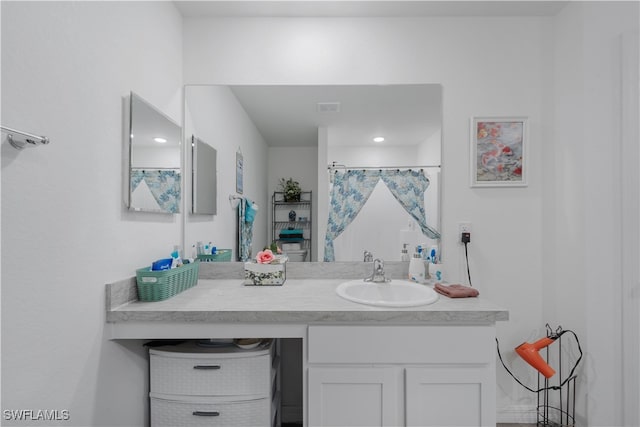 bathroom featuring curtained shower and vanity