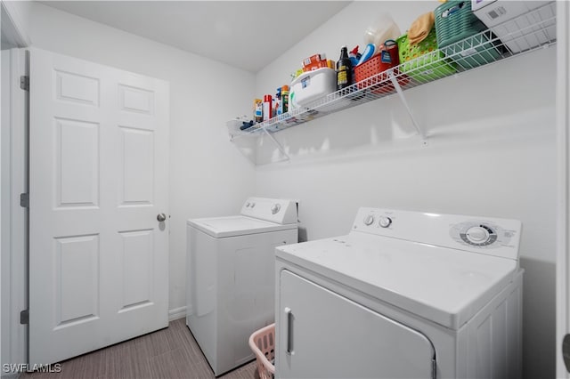 washroom featuring light tile patterned floors and washer and clothes dryer