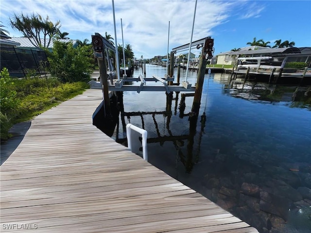 view of dock featuring a water view and boat lift