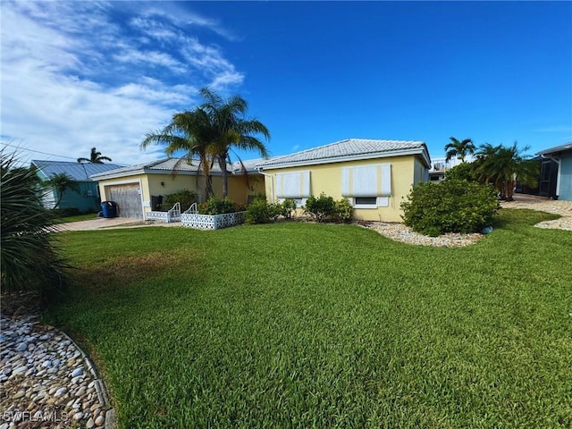 ranch-style house with an attached garage, a front lawn, and stucco siding