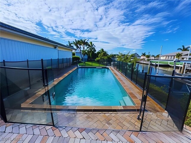 view of swimming pool featuring a water view