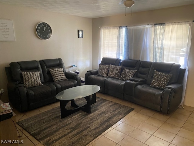 living room with a textured ceiling, light tile patterned floors, and a healthy amount of sunlight