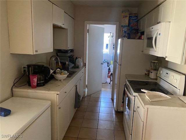 kitchen with white cabinetry, electric stove, sink, and light tile patterned floors