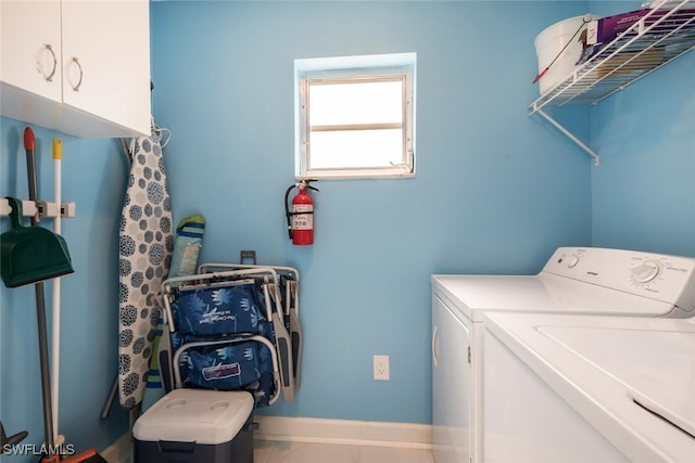 laundry room with cabinets and washer and dryer