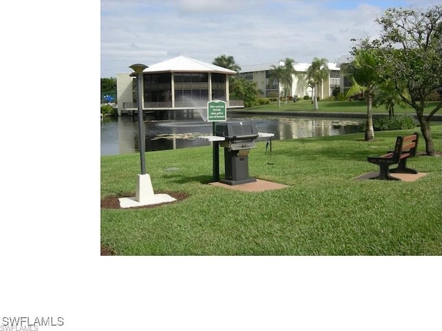 view of property's community featuring a water view, a yard, and a gazebo