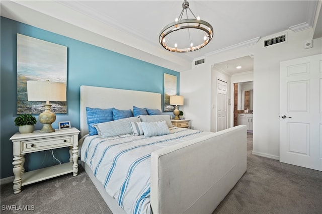 bedroom featuring a notable chandelier, dark carpet, connected bathroom, and crown molding