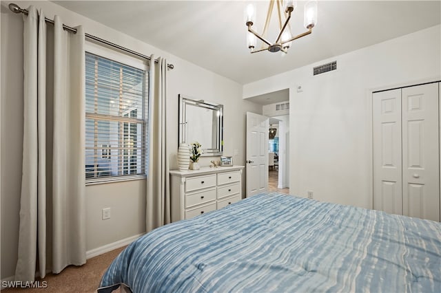 bedroom with an inviting chandelier, a closet, and carpet flooring