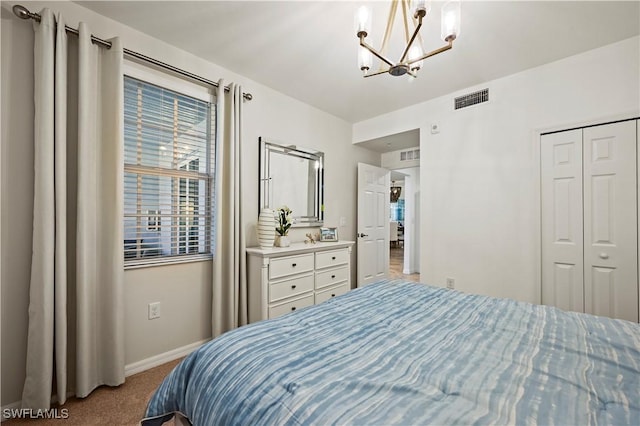 carpeted bedroom with baseboards, a closet, visible vents, and an inviting chandelier