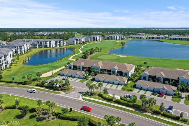 aerial view with a residential view, a water view, and golf course view