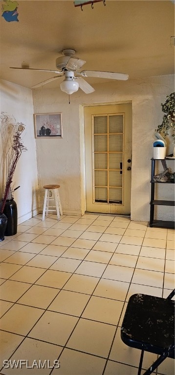 interior space featuring ceiling fan and light tile patterned floors