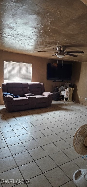 living room featuring ceiling fan and tile patterned floors