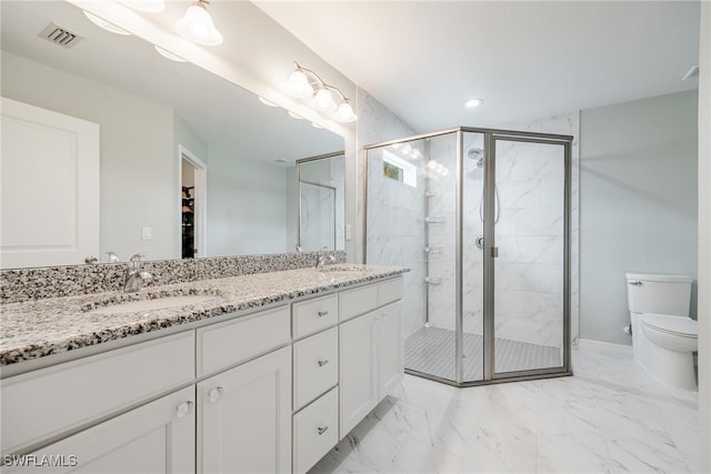 bathroom featuring vanity, an enclosed shower, and toilet