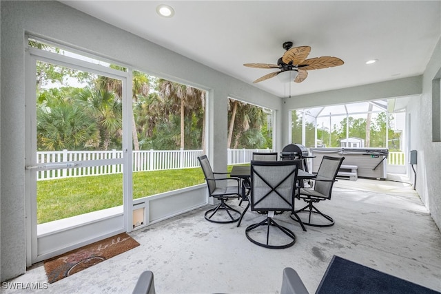 sunroom / solarium with ceiling fan and a healthy amount of sunlight