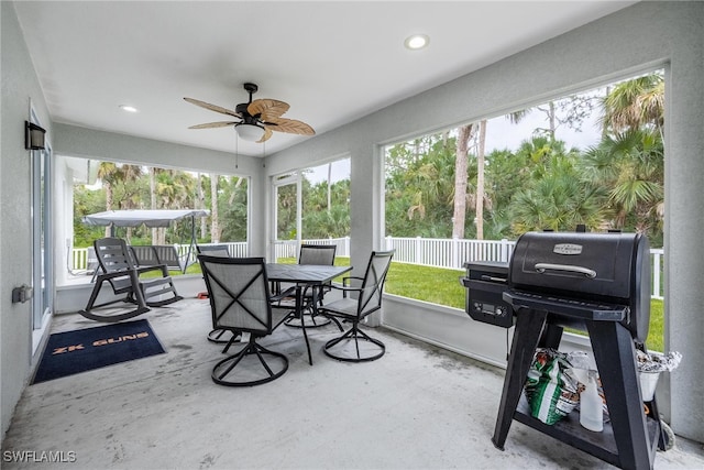 sunroom featuring ceiling fan