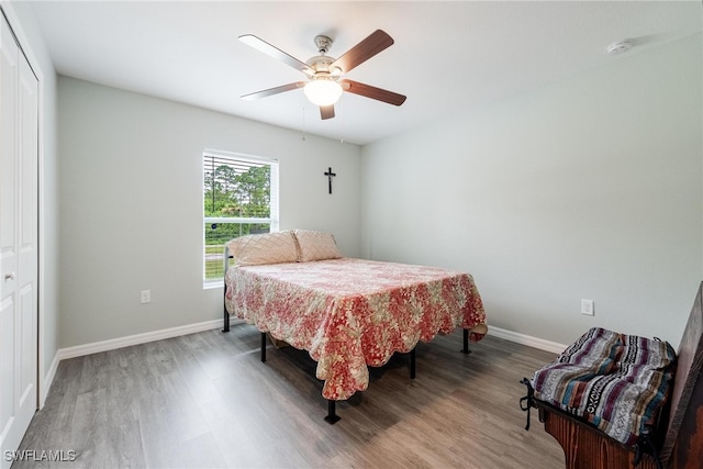 bedroom featuring hardwood / wood-style flooring, a closet, and ceiling fan