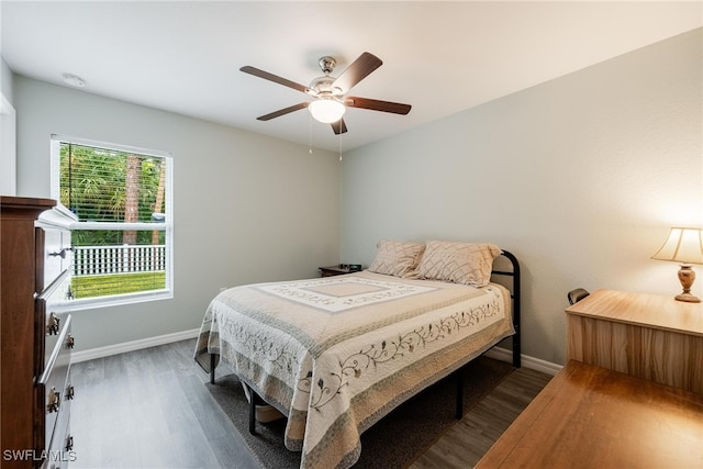 bedroom featuring ceiling fan and dark wood-type flooring