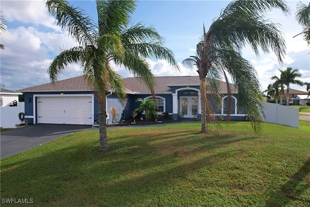 single story home with a garage and a front lawn