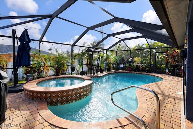 view of pool featuring a patio area, a lanai, and an in ground hot tub