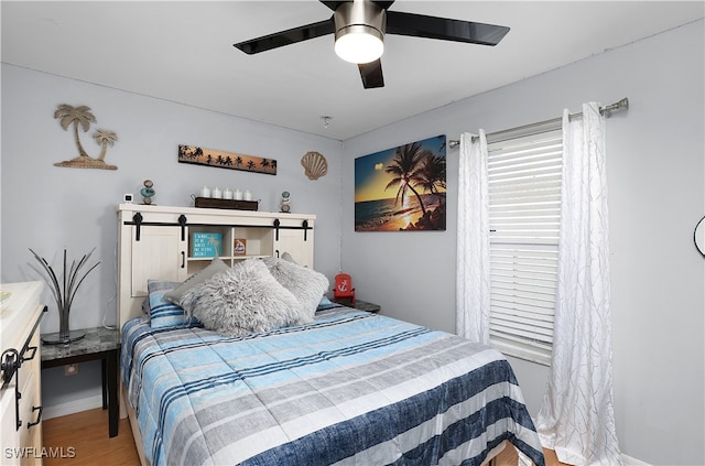 bedroom with hardwood / wood-style floors and ceiling fan