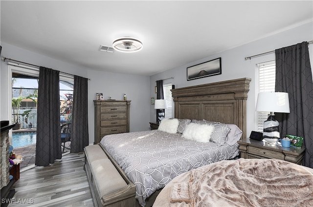 bedroom featuring hardwood / wood-style floors and multiple windows