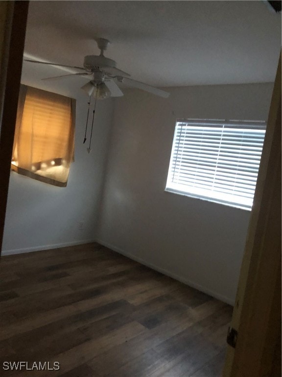 empty room featuring ceiling fan and dark hardwood / wood-style floors